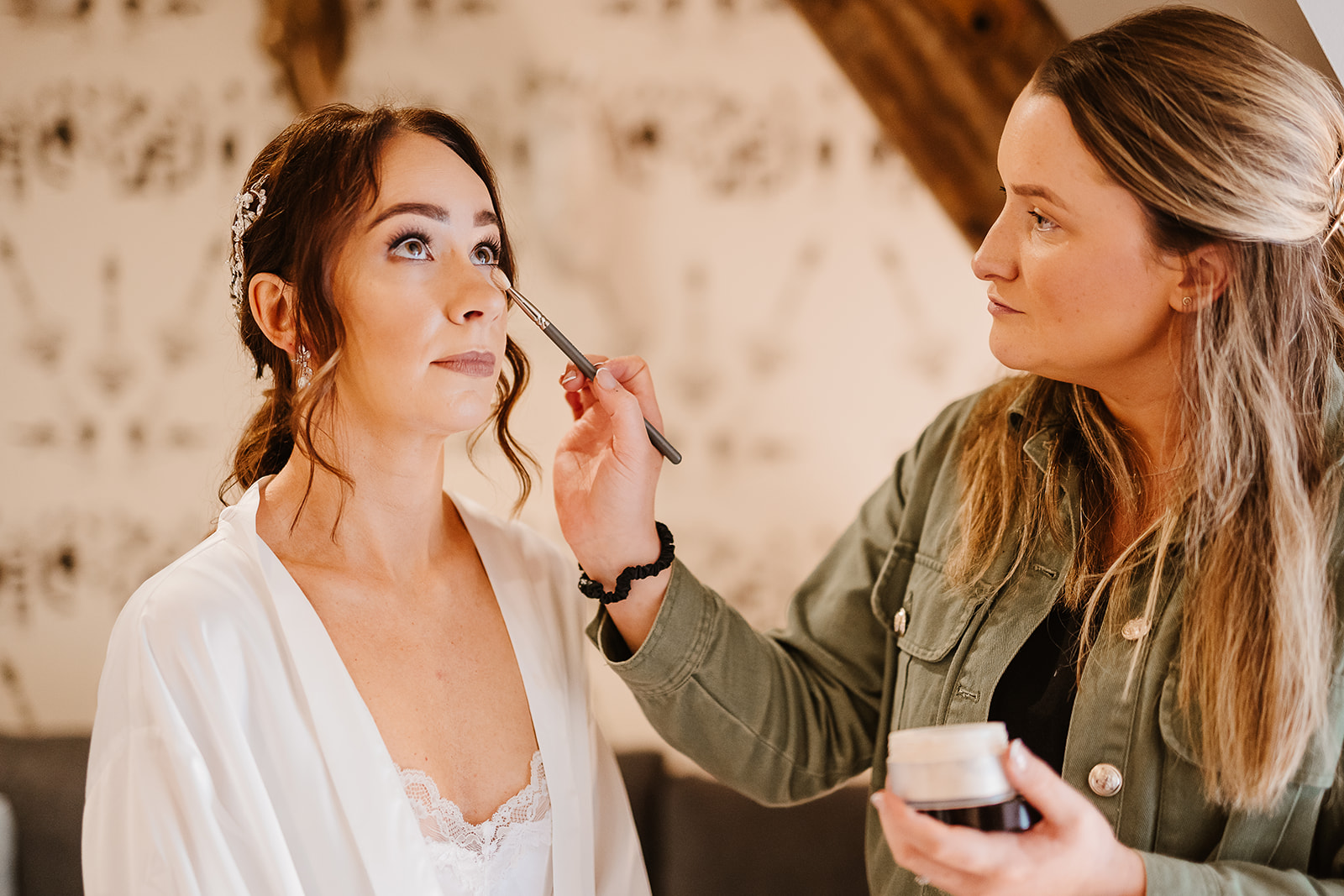 Make up artist adds final details to bride