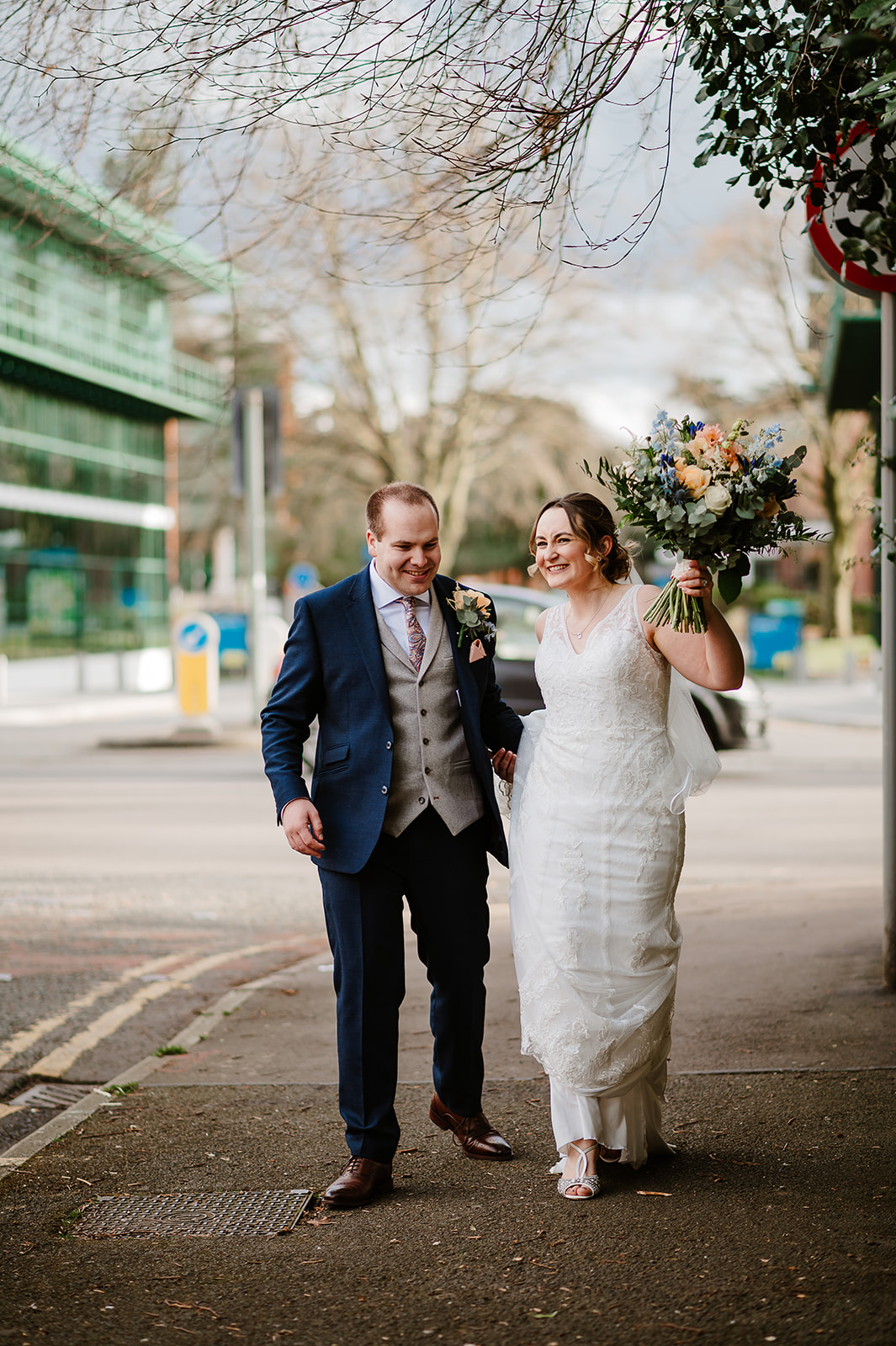 Bride and groom returning along the steet