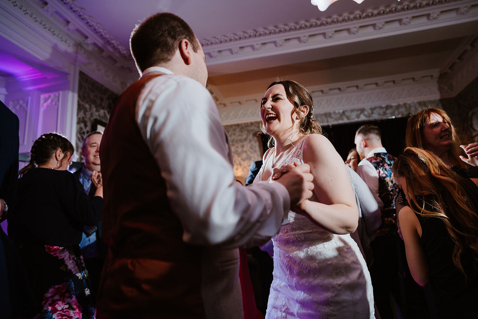 Low angle of bride and groom dancing