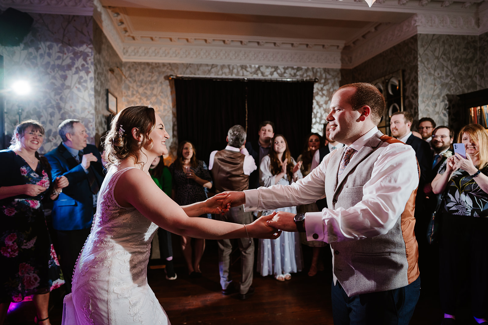 Couple holding hands during first dance