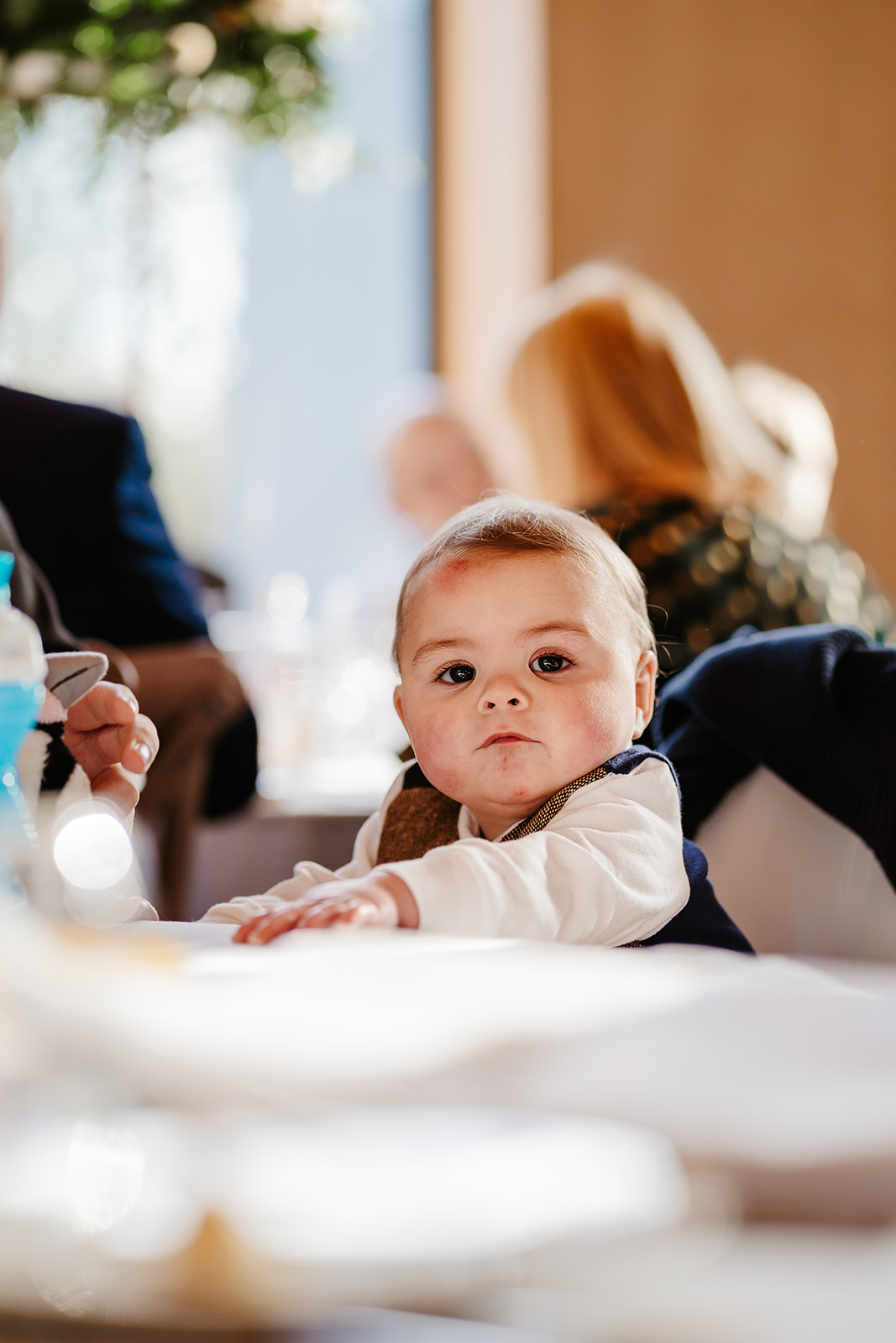 Baby staring over a table