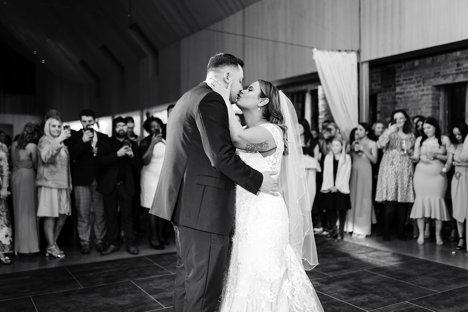 Bride and groom kiss on dancefloor