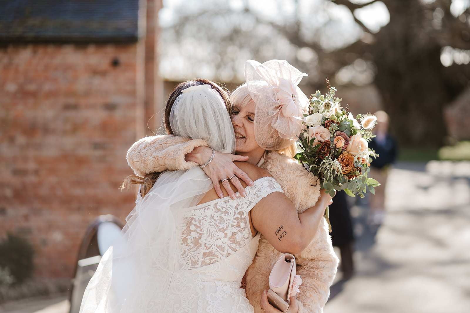 Bride and guest embrace