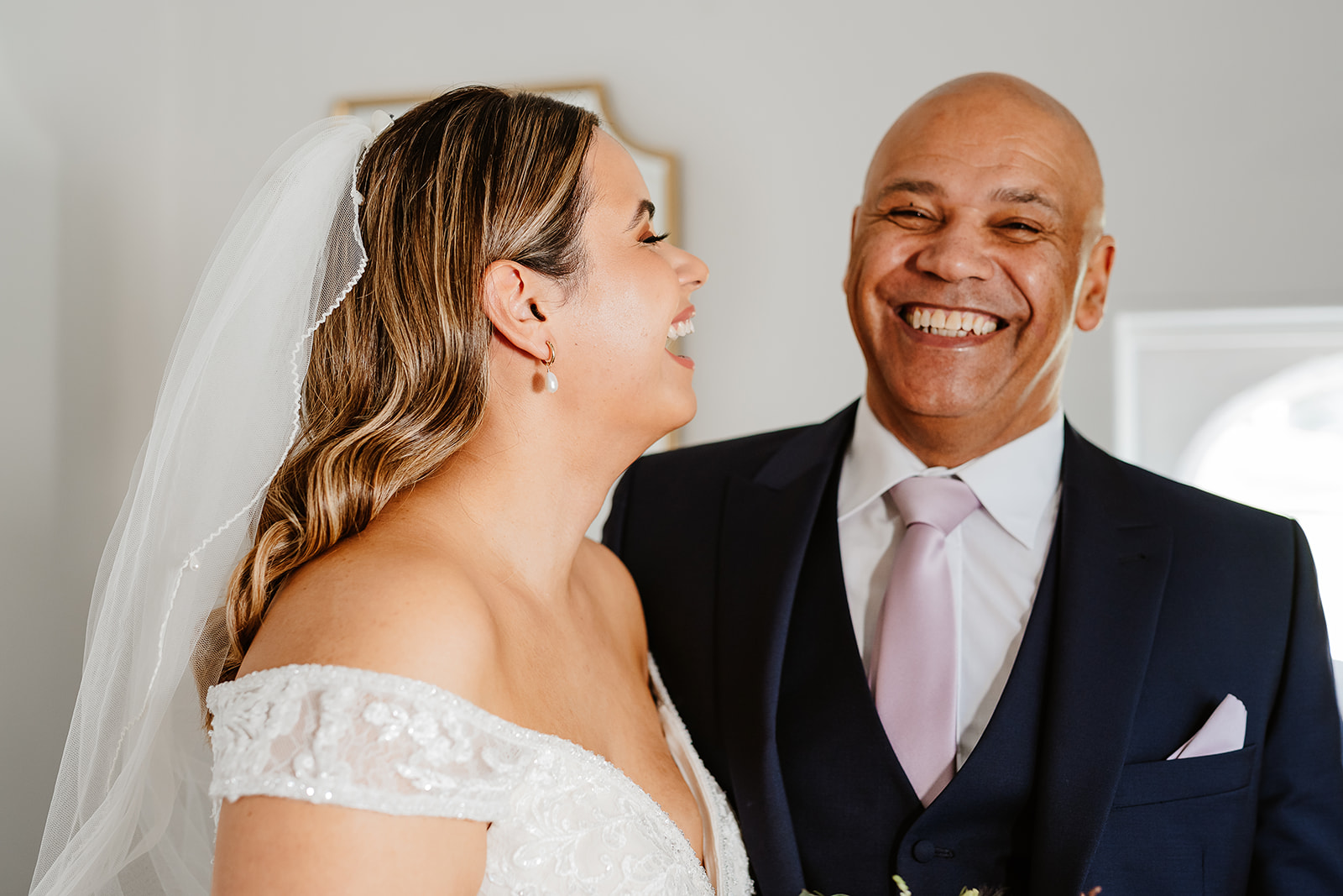 Bride laughing with father