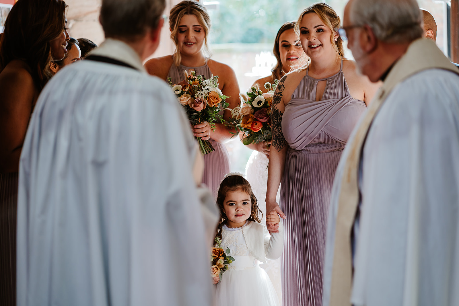Flower girl and bridesmaids waiting in entrance to church