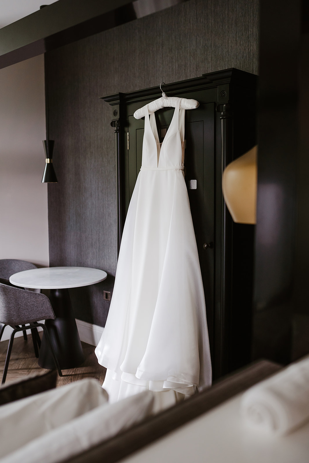 Bride's dress hung on black wardrobe